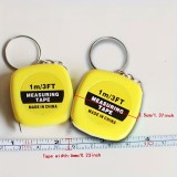 Mini m&egrave;tre ruban porte-cl&eacute;s r&eacute;tractable longueur 1m m&eacute;tallique compact avec double graduation cm/pouces - Jaune